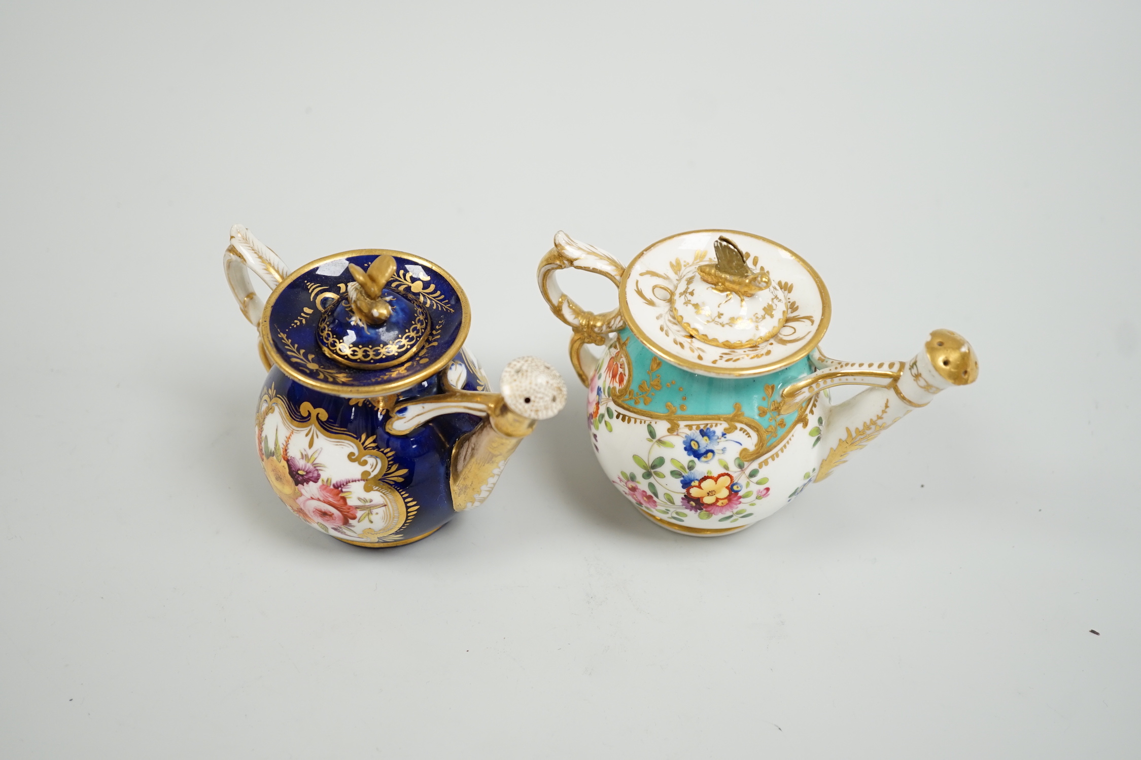 Toy porcelain. Two English rosewater sprinklers, c.1820, possibly Coalport, each modelled in the form of a watering can, tallest 9cm high